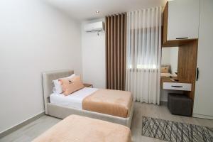a small bedroom with two beds and a desk at Era e Liqenit in Shkodër +39 photos