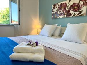 a bedroom with a bed with two wedding shoes on it at Apartments Bella Vita 1 in Malinska