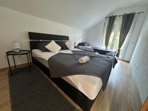 a bedroom with a large bed and a window at Magic Aria Bihac in Bihać