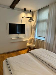 a bedroom with a bed and a flat screen tv at accademia00 in Maastricht