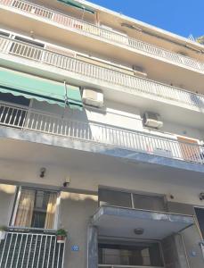 a building with a balcony on the side of it at Athens Acropolis cozy apartment in Athens