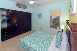 a bedroom with a bed and a ceiling fan at Beachfront Condo, 2 BR - Ocean View at Corto Maltes in Playa del Carmen +8 photos