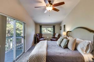 a bedroom with a bed and a ceiling fan at Deck and Game Room Lakeside Blue Jay Chalet Cabin in Lake of the Woods