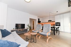 a living room with a couch and chairs and a table at House Tre Venti with pool in Sveti Filip i Jakov
