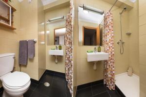 a bathroom with a toilet and two sinks and a shower at LV Premier Marques MQ2 in Porto +14 photos