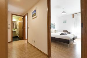 a bedroom with a bed and a mirror at LV Premier Marques MQ2 in Porto