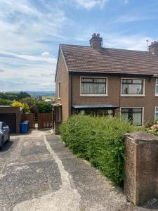 a brick house with a driveway at Prospect Beach House 1, Portstewart in Portstewart
