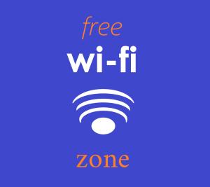 a sign that says free wi fi zone with a wifi symbol at Vista Mare in Mattinata