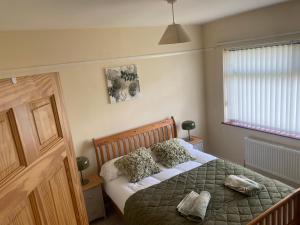 a bedroom with a bed with two pillows on it at Prospect Beach House 1, Portstewart in Portstewart