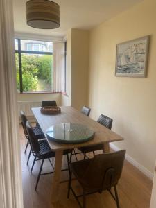 a dining room with a wooden table and chairs at Prospect Beach House 1, Portstewart in Portstewart