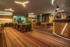 a restaurant with tables and chairs and a bar at Apartman Suada in Fojnica