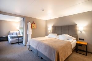 A bed or beds in a room at Hotel AMBiANCE