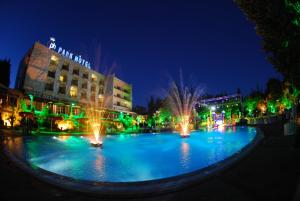 a fountain in the middle of a city at night at Chtaura Park Hotel in Chtaura