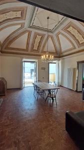 a dining room with a table and chairs and a ceiling at Once upon a time in Domaso