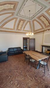 a large room with a large wooden table and chairs at Once upon a time in Domaso