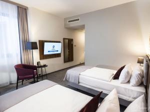 Postel nebo postele na pokoji v ubytování Best Western Hotel Mariacki Katowice