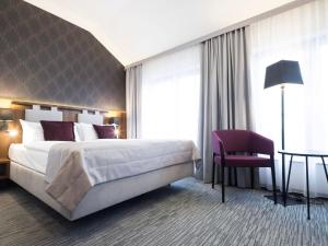 Postel nebo postele na pokoji v ubytování Best Western Hotel Mariacki Katowice