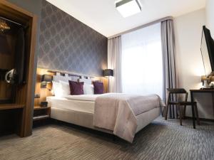 Postel nebo postele na pokoji v ubytování Best Western Hotel Mariacki Katowice