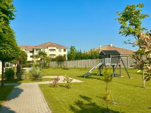 a yard with a playground with a slide at Urban Nest Apartment in Dunajská Streda
