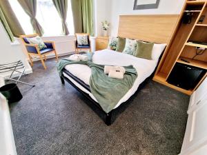 a bedroom with a large bed with two stuffed animals on it at Sweet Rose Guest House Room 6 in Oxford