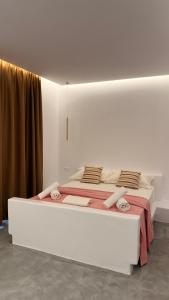 a large white bed in a white room at Rida Village Ksamil Island in Ksamil