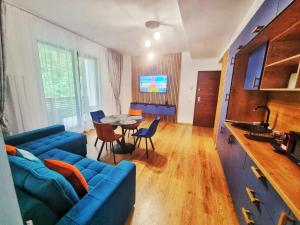a living room with a blue couch and a table at Alpin Confort Predeal in Predeal +43 photos