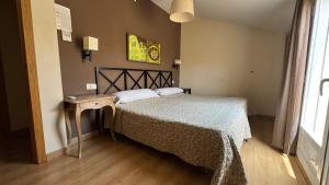Postel nebo postele na pokoji v ubytování Apartamentos Alcazar de Baeza