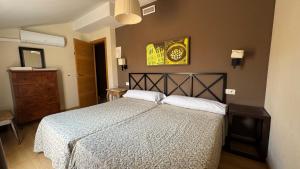 Postel nebo postele na pokoji v ubytování Apartamentos Alcazar de Baeza
