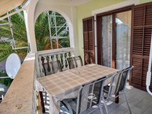 a table and chairs on the balcony of a house at Egidio Gigi Bellich holiday apartments family houses in Rabac