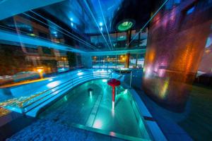 an indoor swimming pool in a building at night at ApartPark Albus1 in Świnoujście
