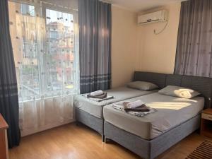 a small bedroom with a bed and a window at Guest house Eos in Sozopol +43 photos