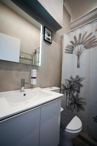 a bathroom with a sink and a toilet and a shower at Hermes Suite Klathmonos by Zeussuites in Athens