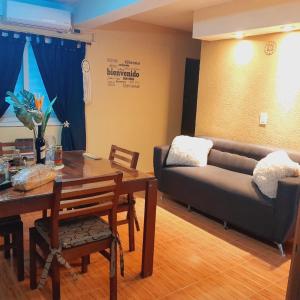 a living room with a couch and a table at Villa Lainez in Villa Mercedes