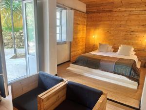 a bedroom with a bed in a room with wooden walls at The Literary Man Obidos Hotel in Óbidos