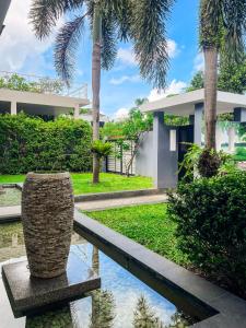 a villa with a swimming pool and palm trees at Tropical Haven 4 Bedroom Pool Villa in Bang Tao Beach