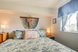 a bedroom with a bed and a window at Ocean Shores Condo with Balcony Less Than 1 Mi to Beach! in Ocean Shores