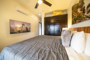 a bedroom with a large bed and a brown cabinet at Condo Surf 405 - Luxury Oceanview Beachfront 3 BR with Gym - At El Faro Condos in Playa del Carmen