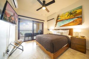 a bedroom with a bed and a ceiling fan at Condo Surf 405 - Luxury Oceanview Beachfront 3 BR with Gym - At El Faro Condos in Playa del Carmen