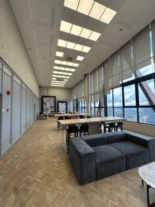 an office with a couch and tables and windows at Scartlez suites KLCC by Dream in Gua Sai +79 photos