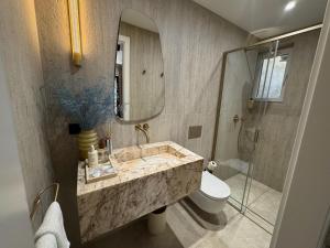 a bathroom with a sink and a toilet and a mirror at Caleda Rooms - Boutique Stay in Dubrovnik Center in Dubrovnik +37 photos