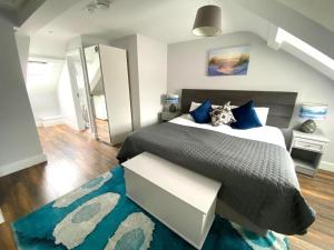 a bedroom with a large bed and a blue rug at 6 New Street SelfCatering BnB Apartment 3 in Bantry