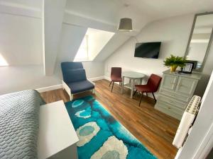 a living room with a bed and a table and chairs at 6 New Street Bantry Studio Apartment 3 in Bantry