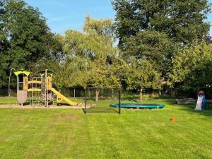 a park with a playground with a slide at De Specht in Doetinchem
