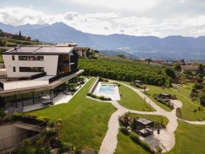 an aerial view of a house with a garden and a pool at Stollhof in Lagundo
