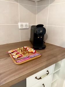 a toaster and a tray of donuts on a counter at Le Herriot 3 - Proche de la gare in Brive-la-Gaillarde