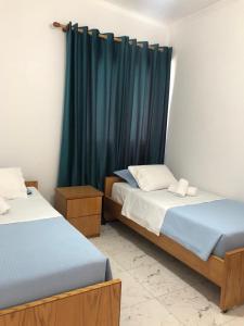 Postel nebo postele na pokoji v ubytování Guest House Nino's