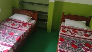 Ένα ή περισσότερα κρεβάτια σε δωμάτιο στο Jayaram gokulavasam