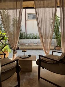 a living room with two chairs and a table at Caleda Rooms - Boutique Stay in Dubrovnik Center in Dubrovnik