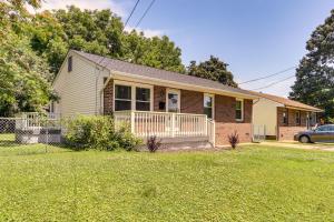 a small house with a porch and a yard at 4 Mi to Hampton Coliseum Home with Yard! in Newport News