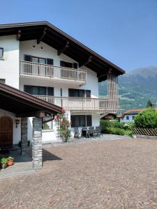 a large white building with a balcony and a patio at Ferienhaus Gioia in Schruns-Tschagguns